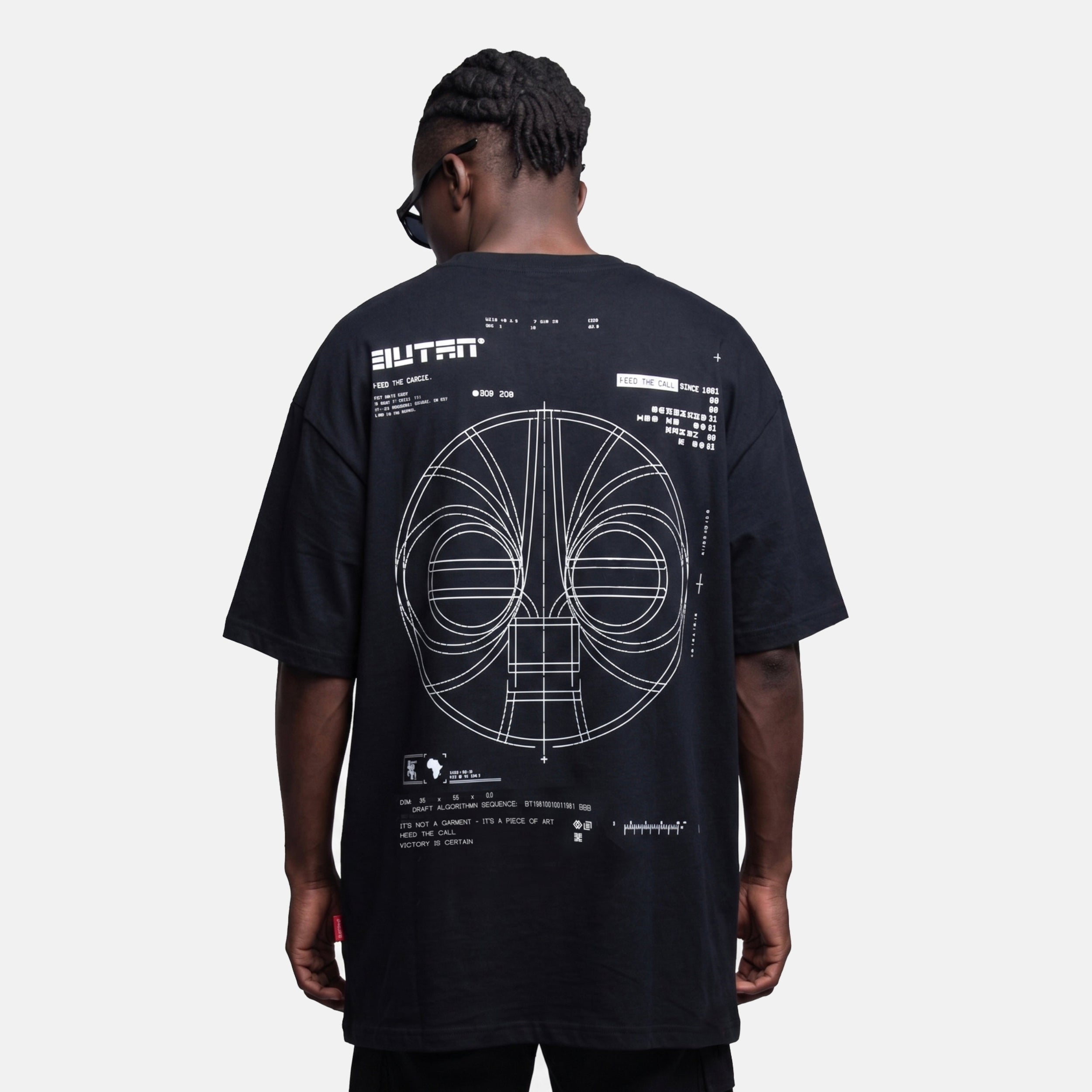 Person wearing a black t-shirt with a design on the back against a white background