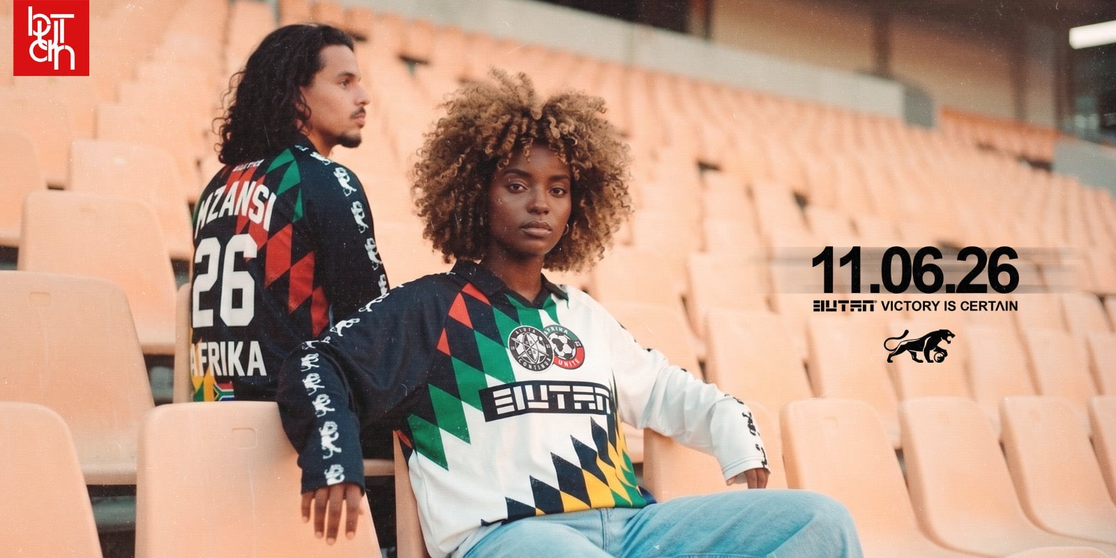 Two people wearing sports jerseys in an outdoor setting with a visible brand logo.