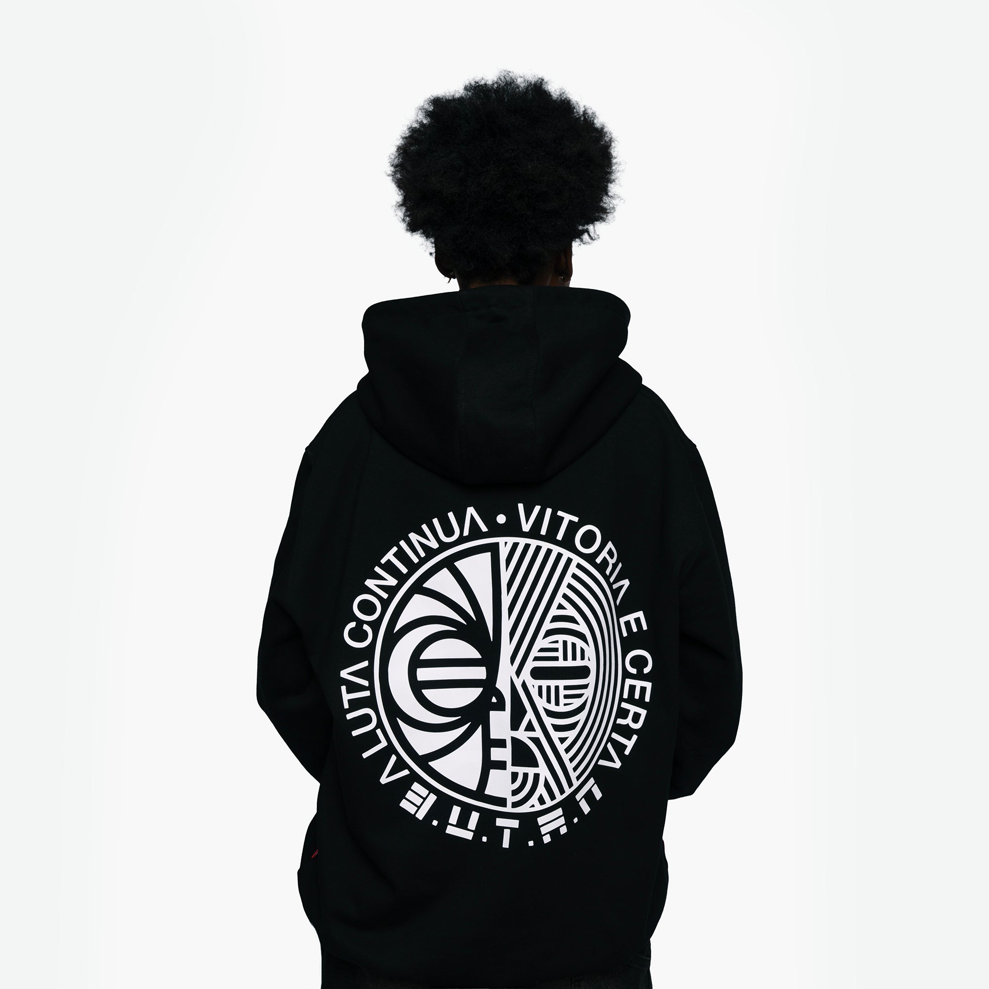 A person viewed from the back wearing a black hoodie with a large white circular graphic and text printed across the back, set against a plain white background.