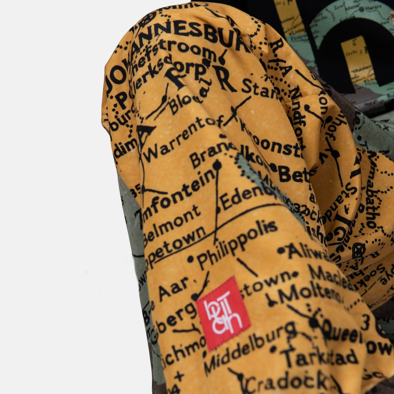 Pair of mittens with a map design and a visible brand logo on a white background