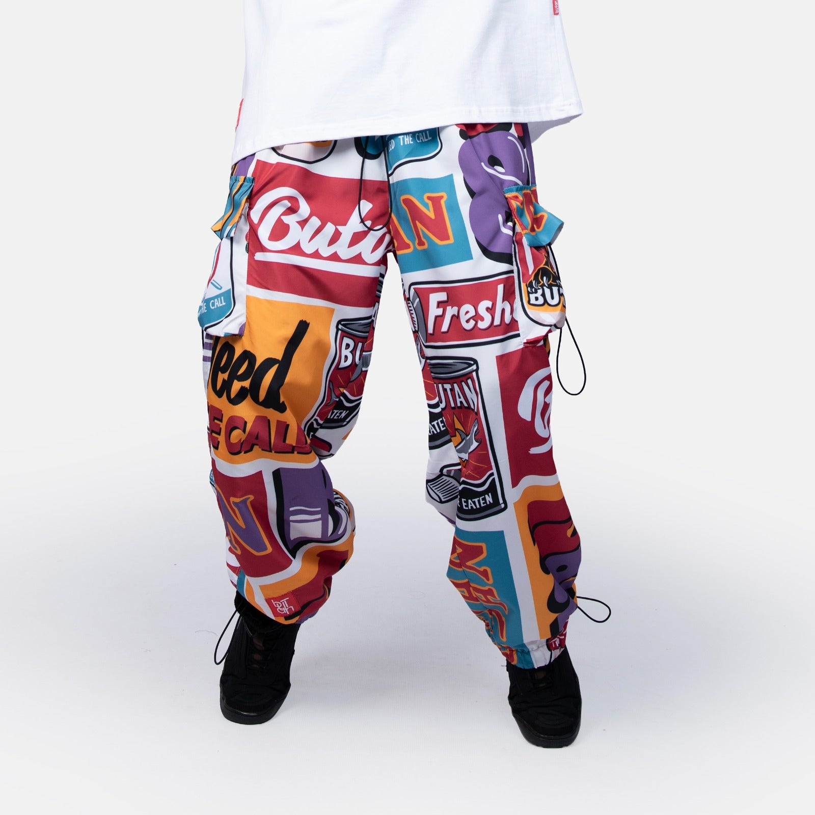 Colorful graphic pants with text and logos on a white background