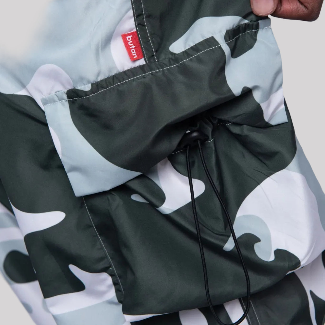 Camouflage jacket with a brand logo on a white background