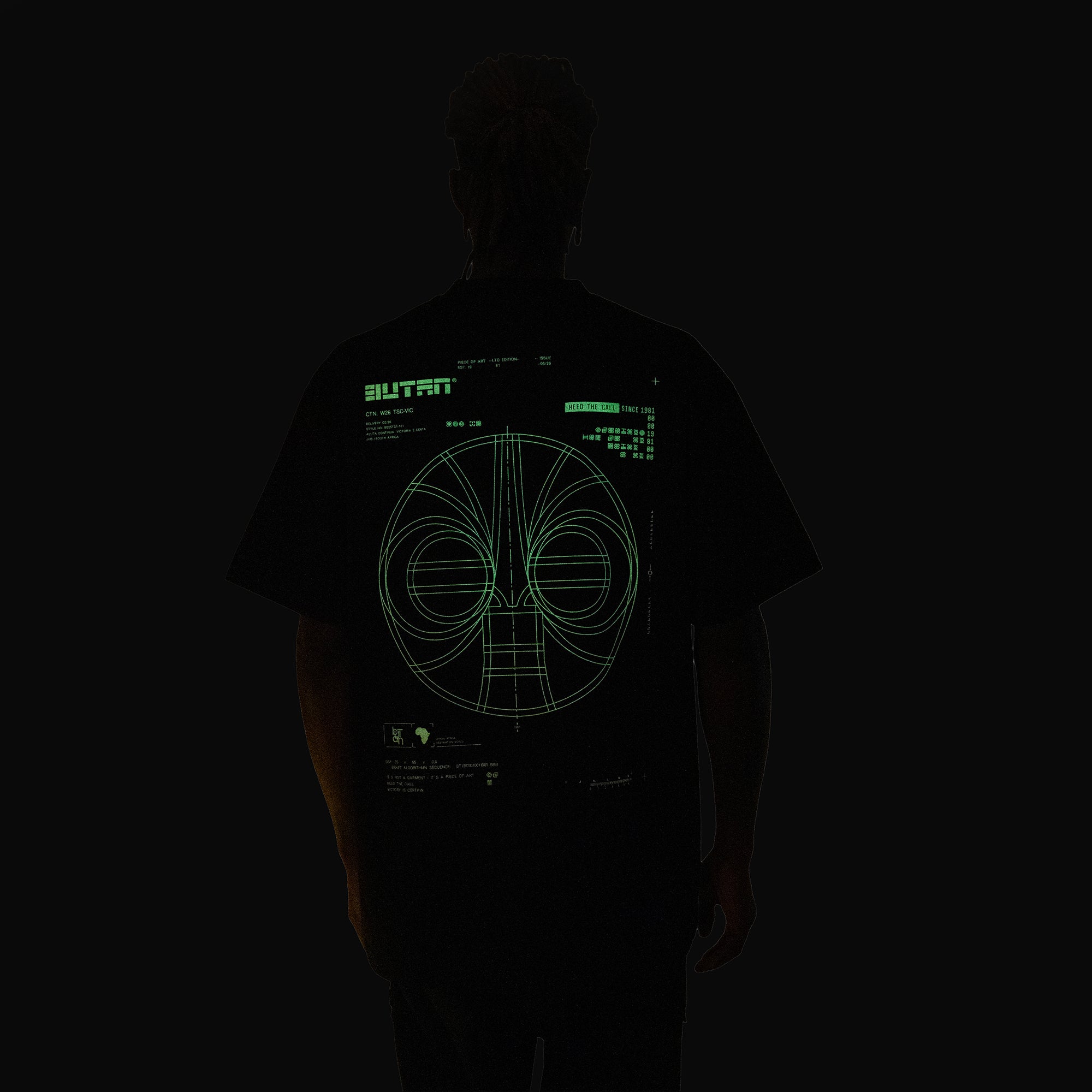 A person shown from behind wearing a black t-shirt with a glowing green futuristic graphic and the word 'BUTAN' printed on the back, set against a completely black background.