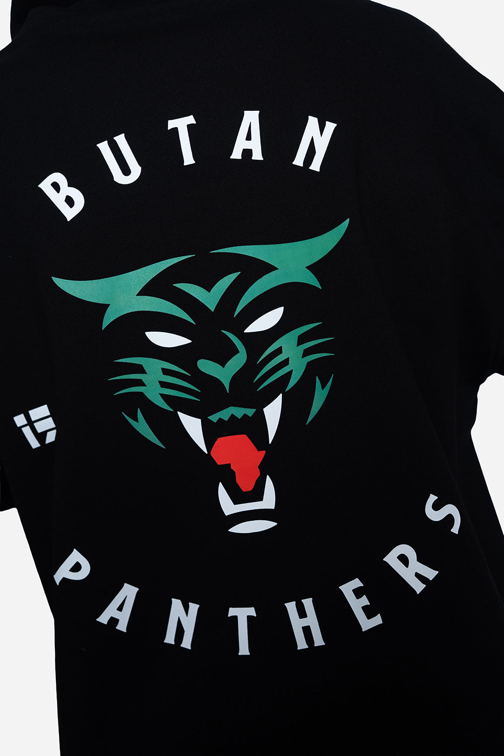 Close-up of a black t-shirt featuring a graphic print of a green panther face with a red tongue, surrounded by the text 'BUTAN PANTHERS' in white.